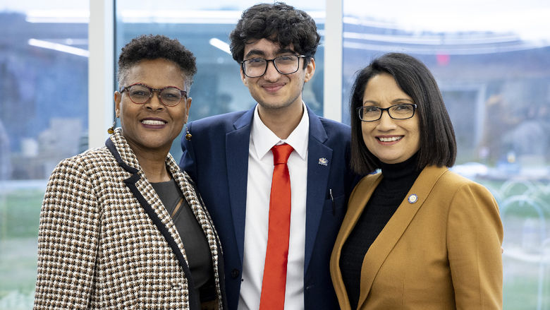 Dr. Richardson, Kriday Sharoma, and President Bendapudi stand together and smile at the camera.