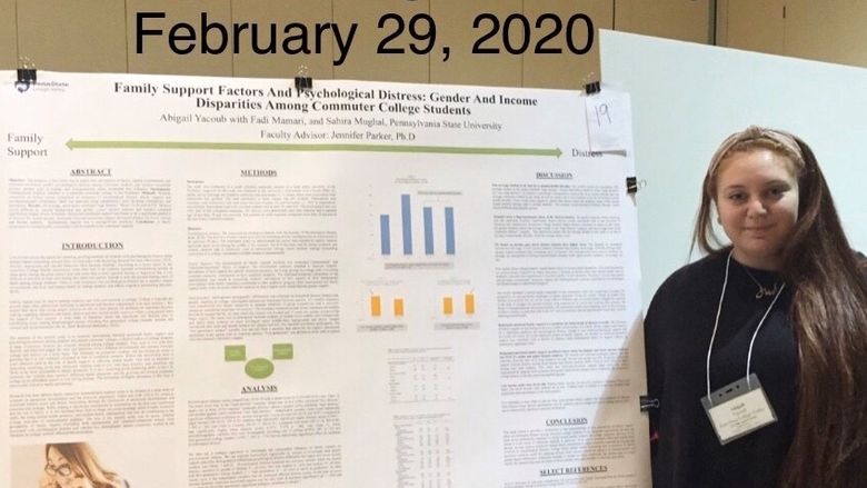 female student with her research poster