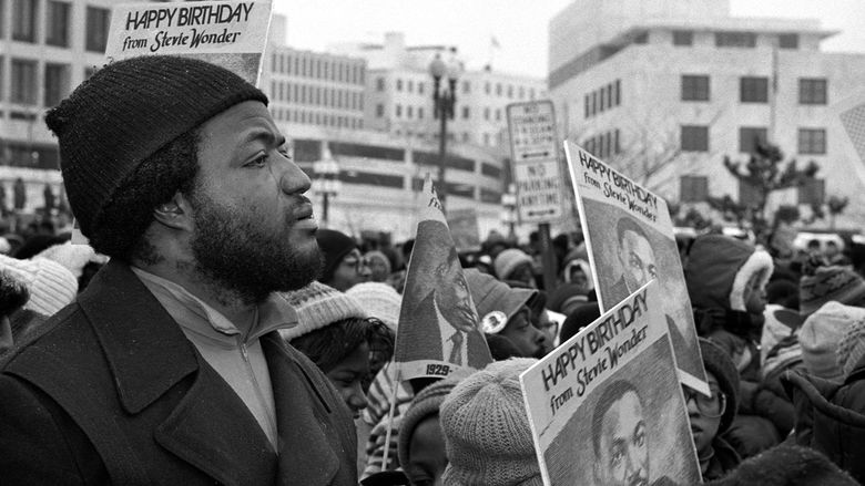 Man with tear running down his face in a crowd at a Dr. Martin Luther King celebration.