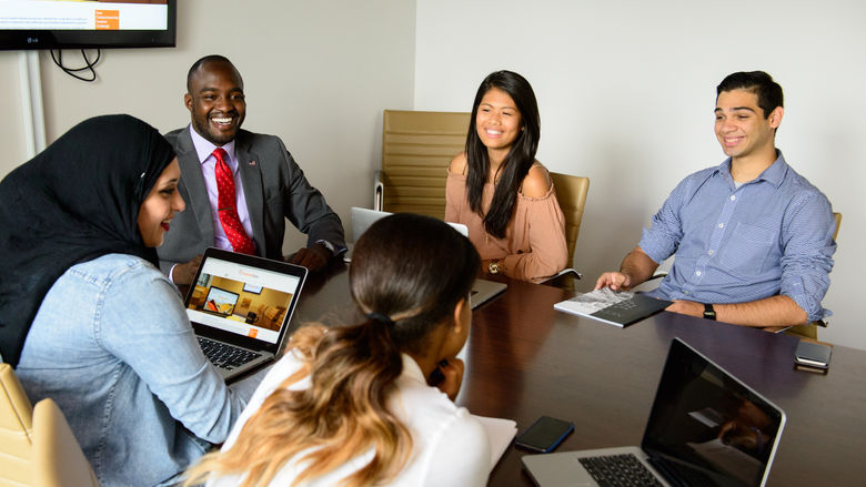 Group of people around a table talking