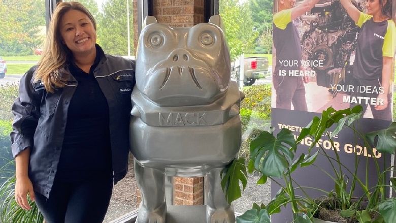 Vernell Daniels near statue of Mack truck bulldog