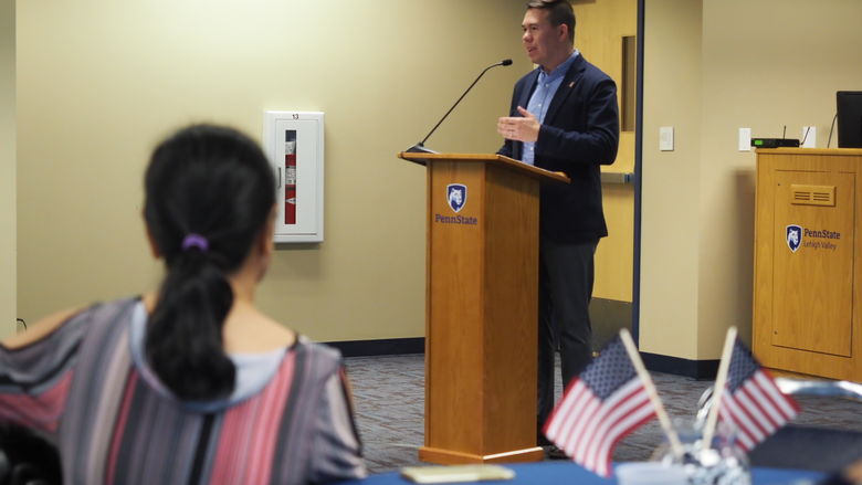 man speaking at podium