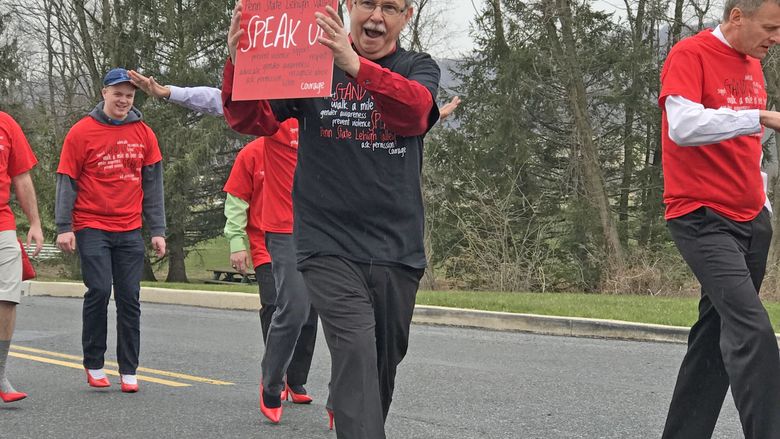 man in red heel holding sign 