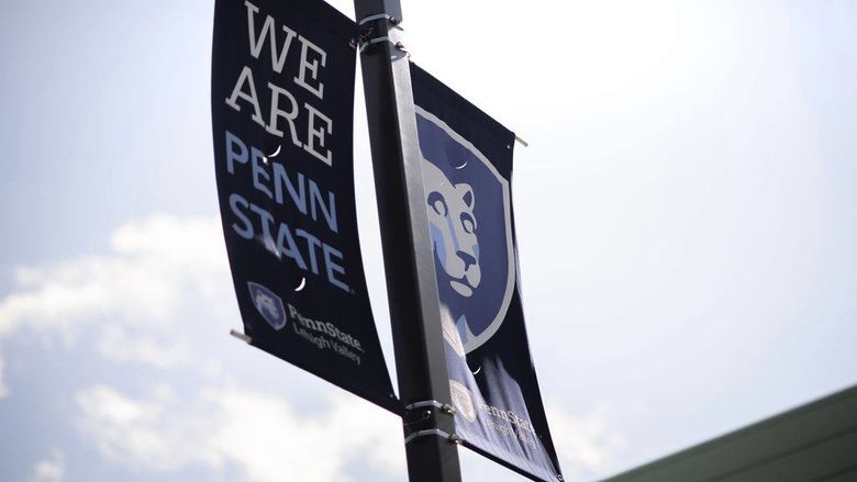 banners on campus reading "we are penn state" 