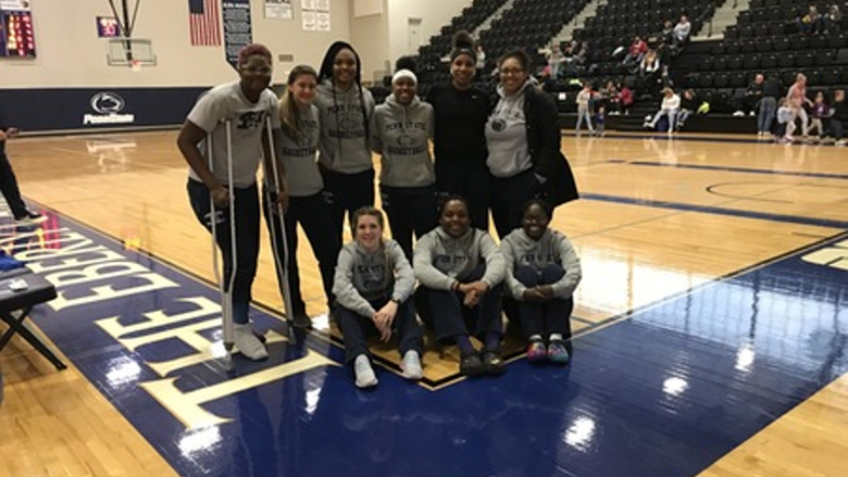 women's basketball team after a game on the court for group photo