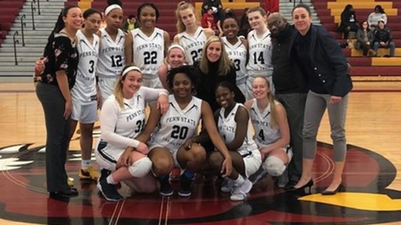 group shot of women's basketball team with guest coach