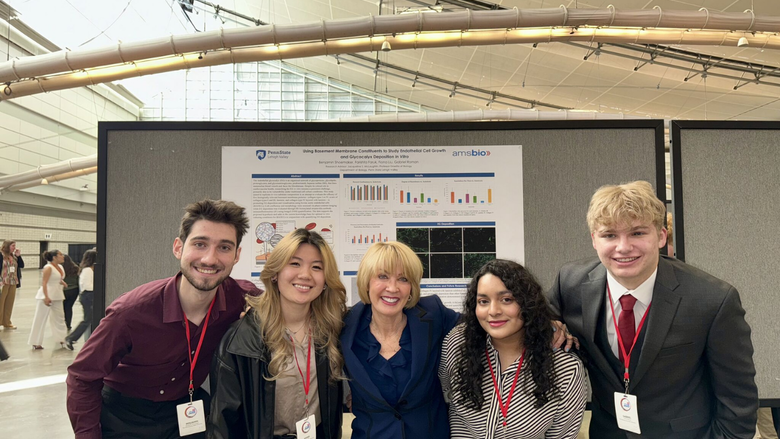 four biology students pose together at a conference