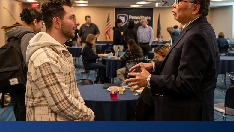 a professor and local businessman engage in conversation