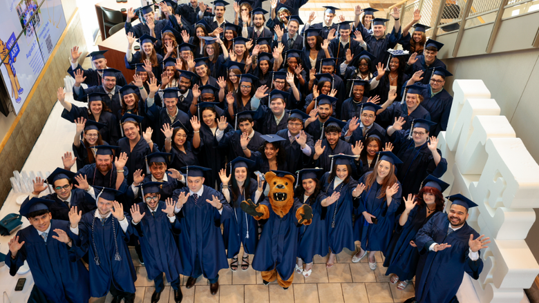 Penn State Lehigh Valley grads smile with the nittany lion on commencement day