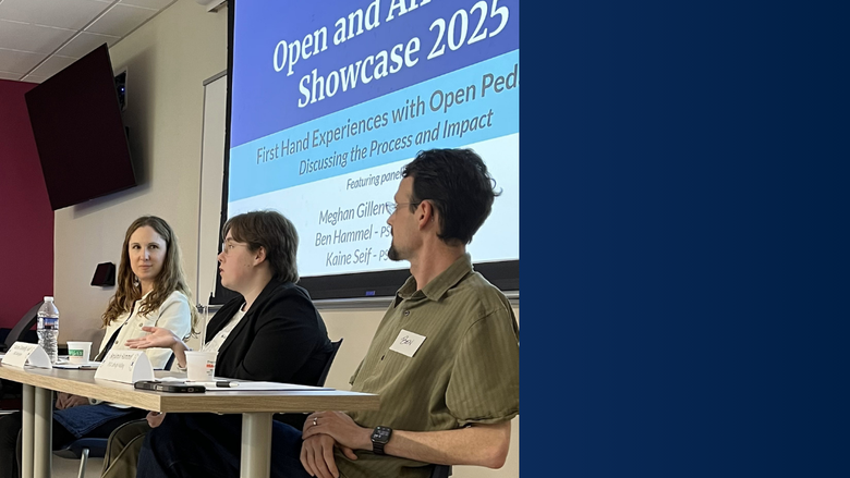 3 faculty members sit at a table in front of a projector in a classroom and look at each other 