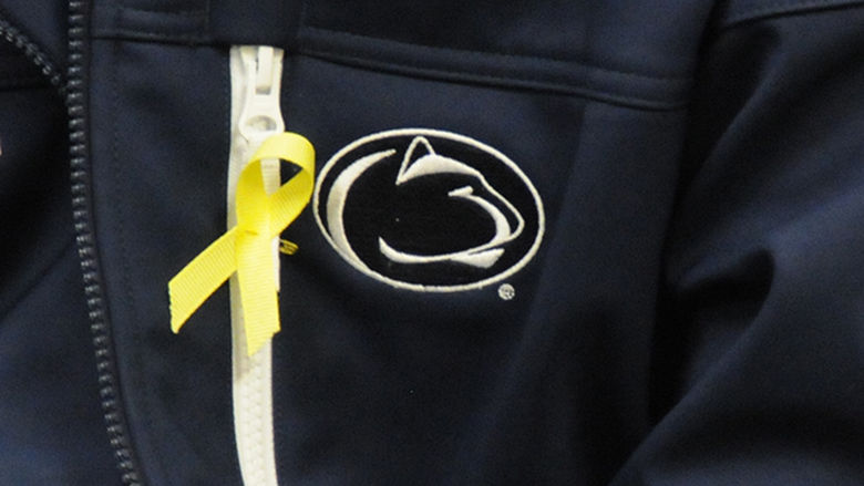 A student wears a yellow ribbon in honor of Veterans Day.
