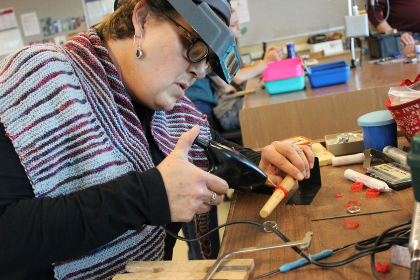 woman creating jewelry in a workshop