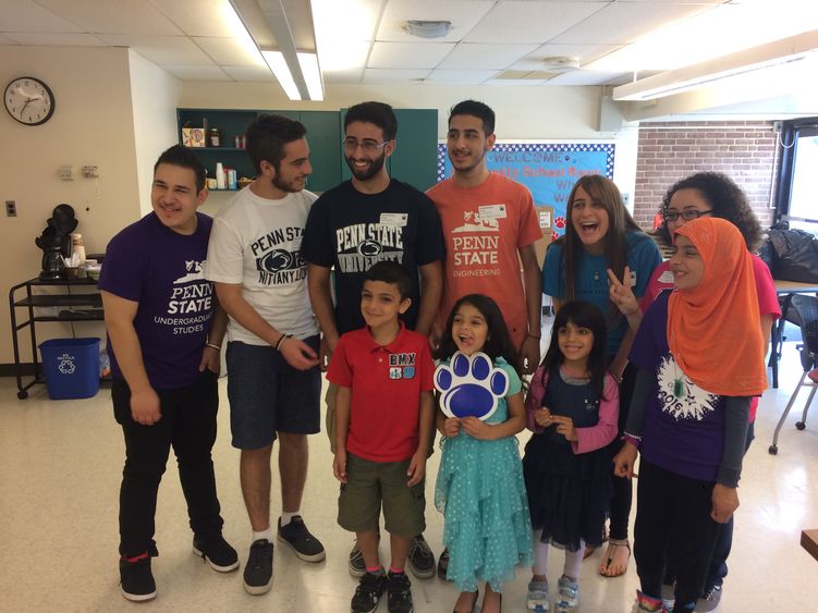 Group of college students and elementary school students