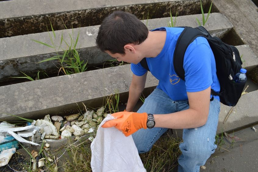 A man picks up trash