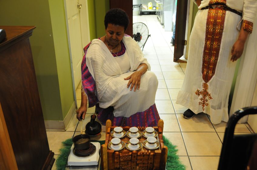 Woman making Ethiopian coffee