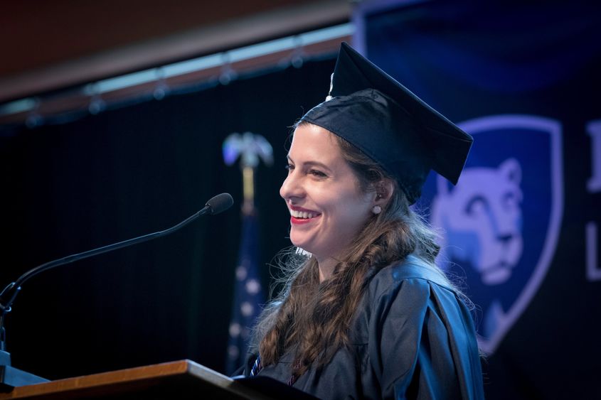 Woman speaking at commencement ceremony at a podium