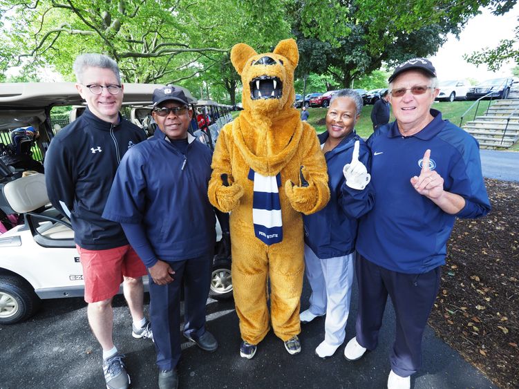 Four golfers and nittany lion
