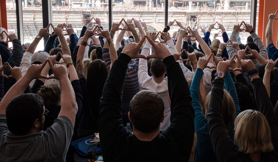 Group of people put their hands up in diamonds shape