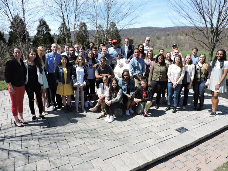 Group of student athletes posing near Lion Shrine Group of student athletes posing near Lion Shrine
