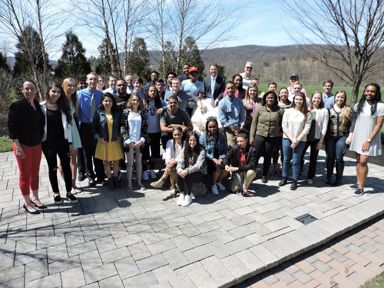 Group of student athletes posing near Lion Shrine