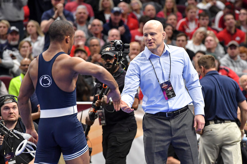 Cael Sanderson shaking a wrestler level