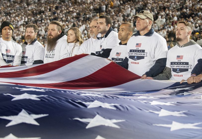 Veterans hold flag Veterans hold flag