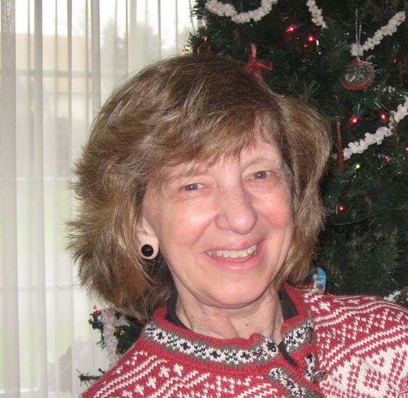 Photo of Kathy Gray in front of Christmas tree