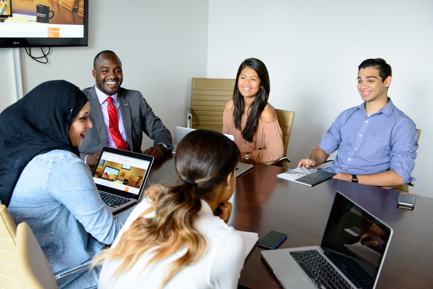 Group of students with laptops working at a desk