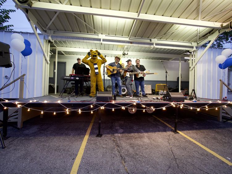 the nittany lion on stage with a band