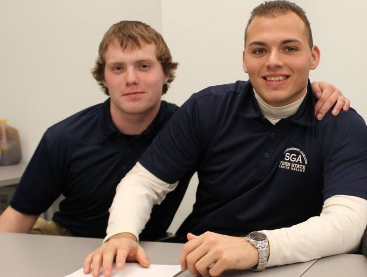 Two students pose with arm around each other Two students pose with arm around each other