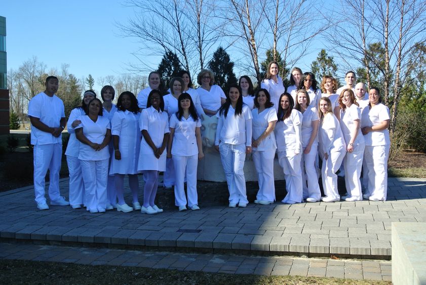 Group of LPN graduations near lion shrine