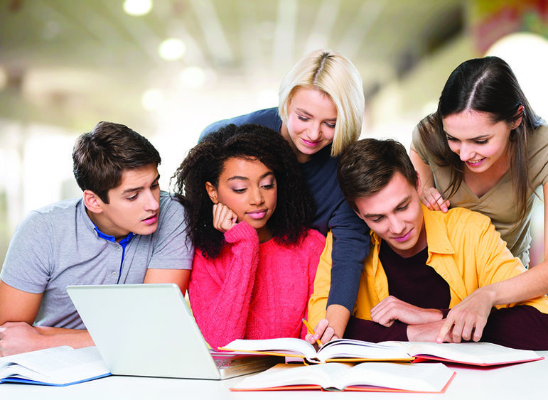 Group of teenagers working at a table