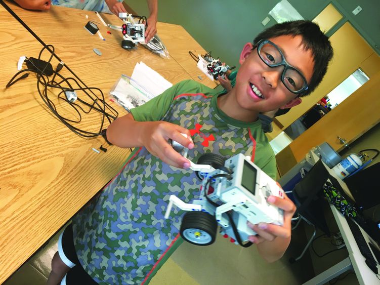 boy holding a robot