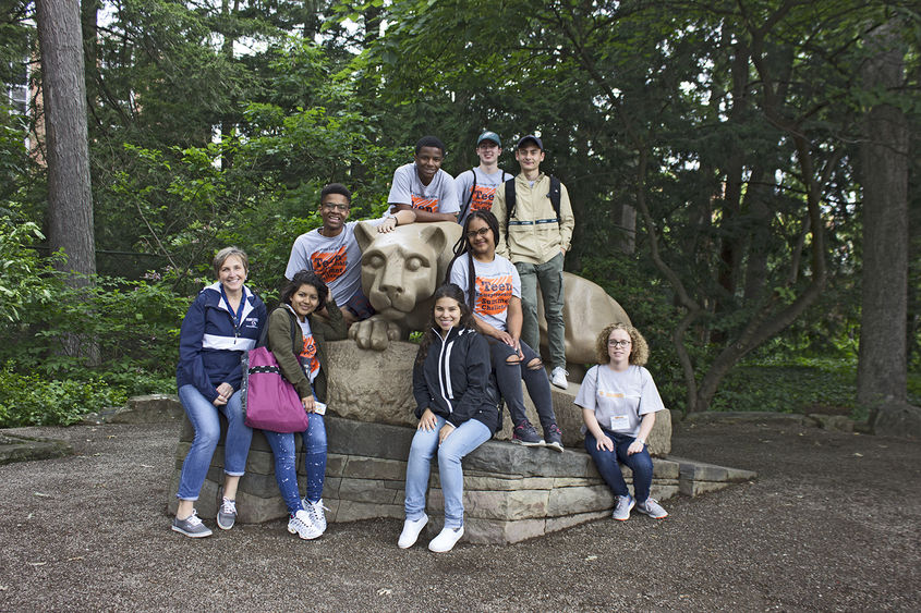 Campers posing around Nittany Lion