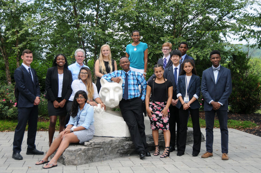 group pose around lion shrine