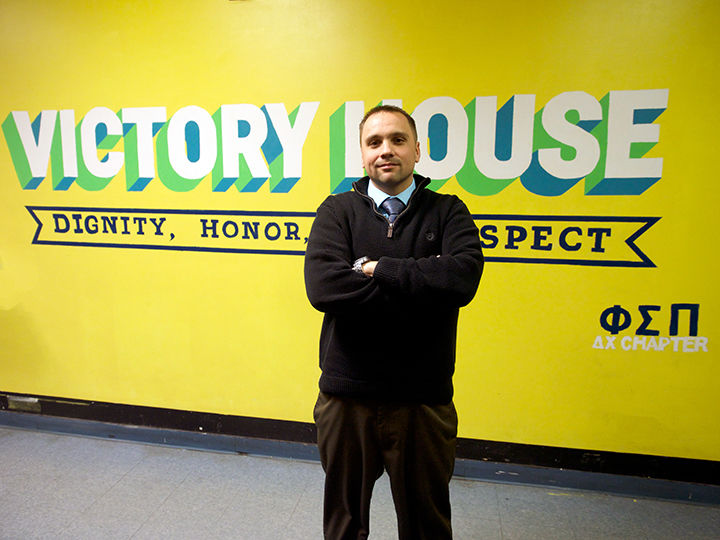 young man in front of a mural