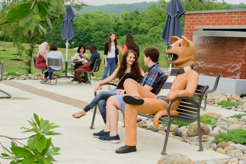 Students by Nittany Lion bench at Student Plaza