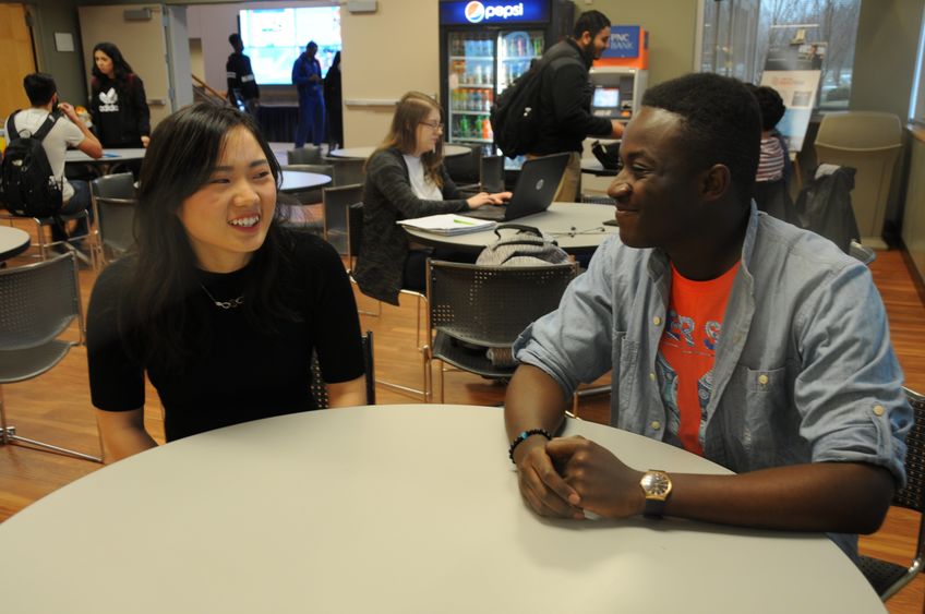 Two students sitting at a table in Lion's Den cafeteria