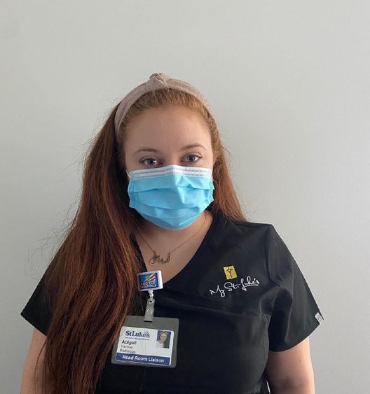 young woman in scrubs and face mask