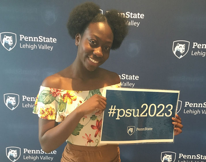 young student holding sign with #psu2023