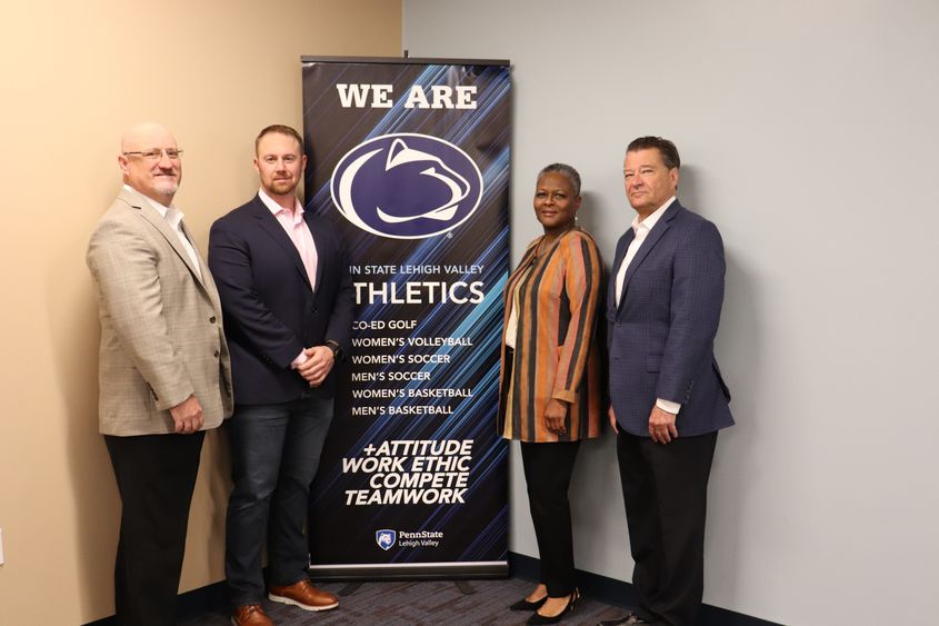 four people near athletics banner