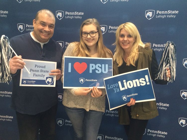 Family posting with PSU signs