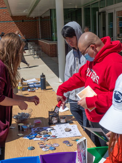 Students make buttons at Arts Fest