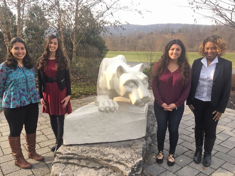 four female students by lion shrine