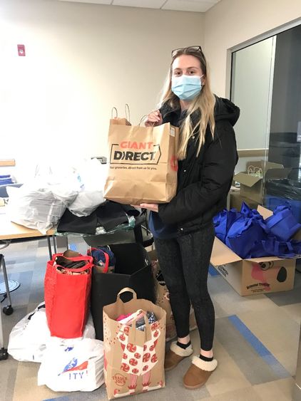 Victoria Stopper holds clothing bag donation 
