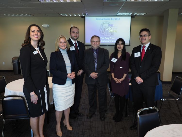 Group of men and women in professional dress at a conference