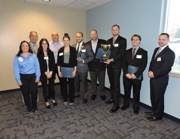 group of men and women with awards