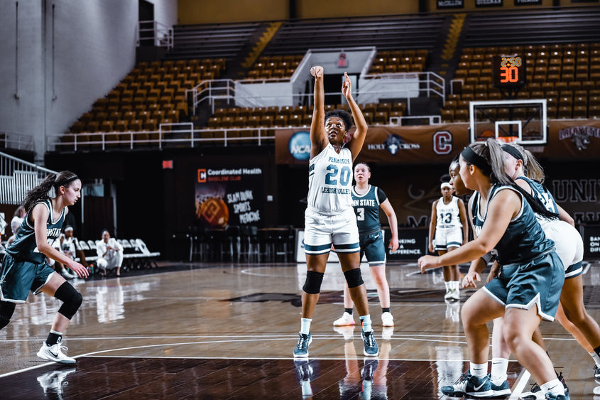 young woman shooting a foul shot