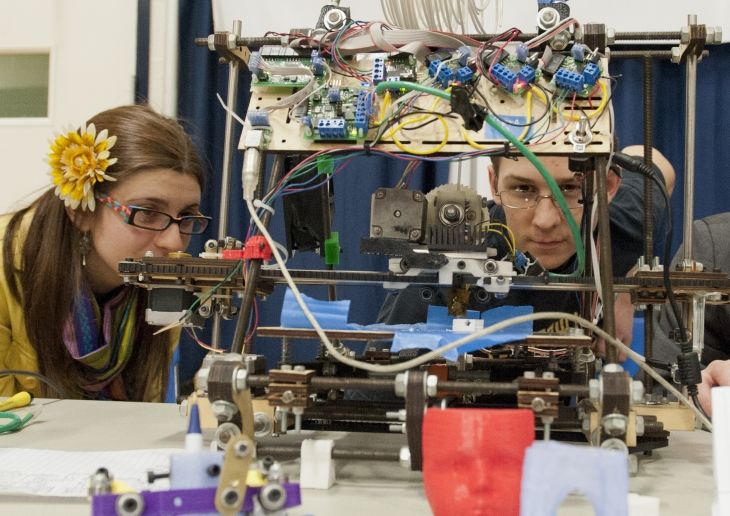 Students looking at a machine