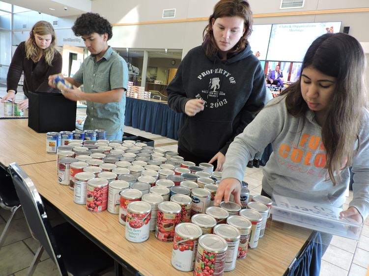 Students fill bags of food